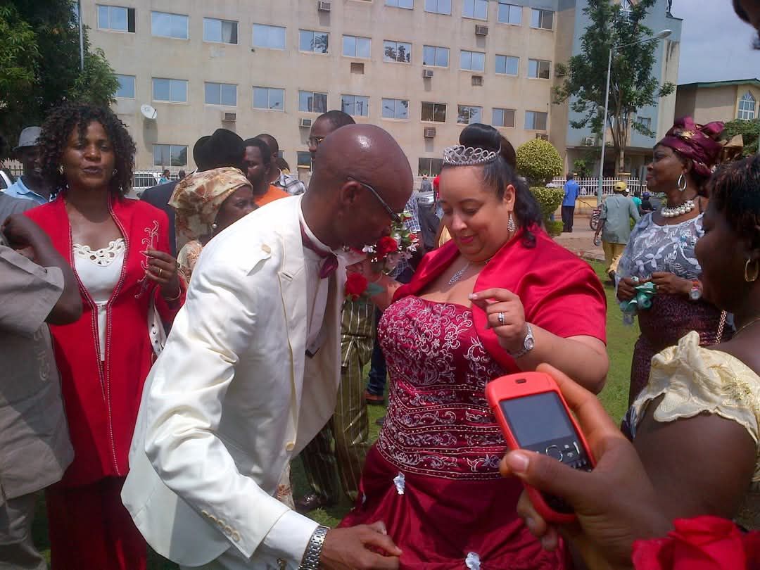 Wedding celebration with guests in elegant attire.